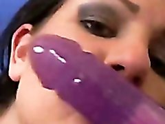 Sucking on a dildo and fucking her pussy with it